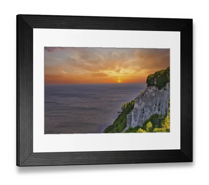 Framed Print : Majestic view of cliffs on a coast with a glowing sunset in the background Framed Print : Majestic view of cliffs on a coast with a glowing sunset in the background