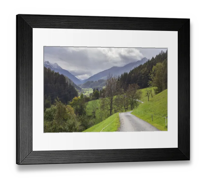 Framed Print : Road with mountains, dark clouds and forest in the Stubai Valley between Telfes and Mieders
