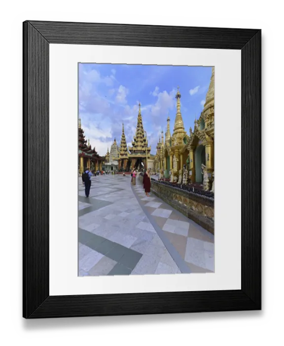 Framed Print : People and monks explore an impressive temple complex under clear skies Framed Print : People and monks explore an impressive temple complex under clear skies