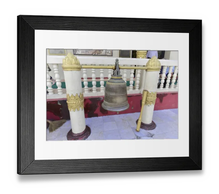 Framed Print : Large bell between decorated pillars in a temple area