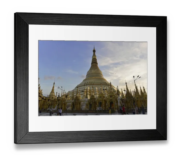 Framed Print : Sunset deepens the silhouette of a huge stupa on the human-filled temple grounds