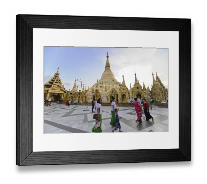 Framed Print : Family walking in front of a large golden pagoda in the evening Framed Print : Family walking in front of a large golden pagoda in the evening