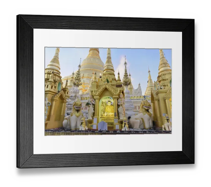 Framed Print : Golden sculptures and carved figures in front of a pagoda