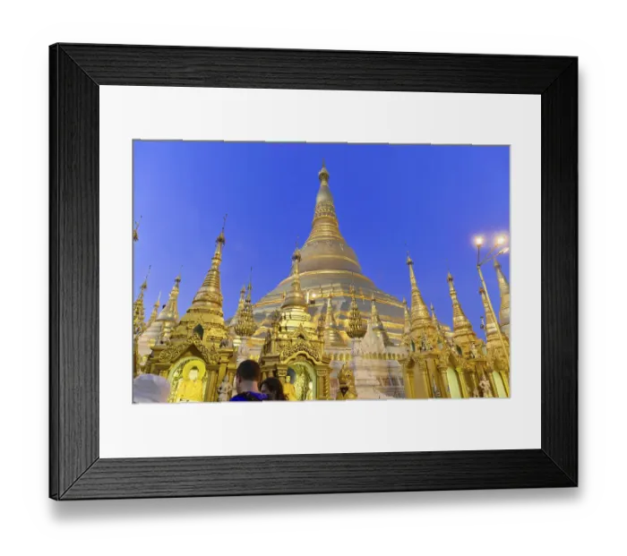 Framed Print : Light illuminates majestic stupas at night in a temple complex