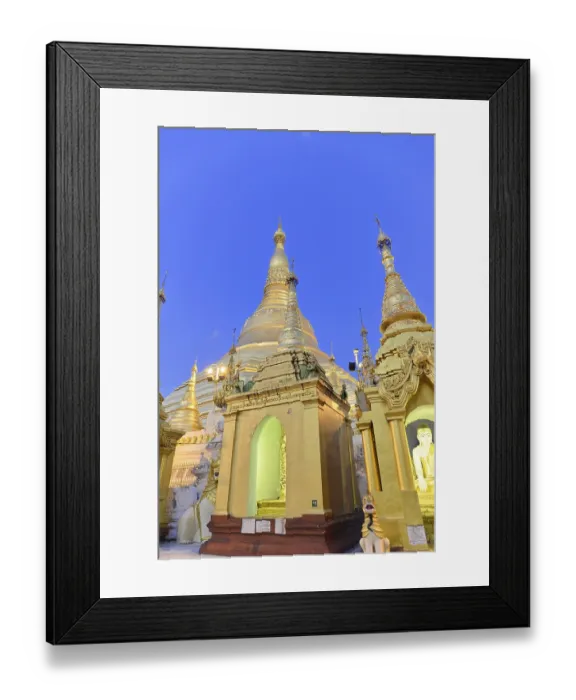 Framed Print : Golden stupas of a temple at dusk on a clear evening