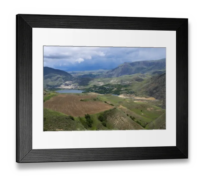 Framed Print : Mountains and valleys with agricultural fields under cloudy sky