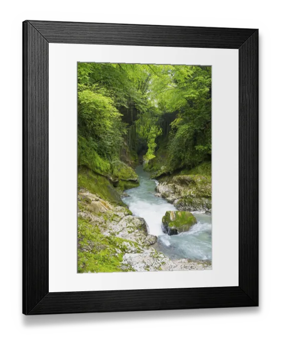 Framed Print : Calm flowing river through green forests and rocky surroundings