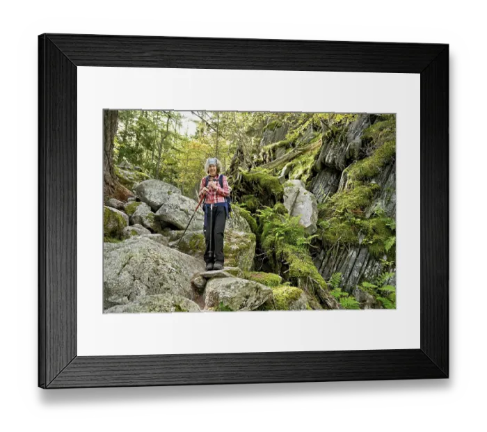 Framed Print : Female hiker on mountain tour standing in rocky terrain
