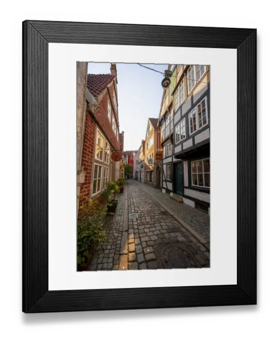 Framed Print : Colourful houses with shops and half-timbered houses in a small alley