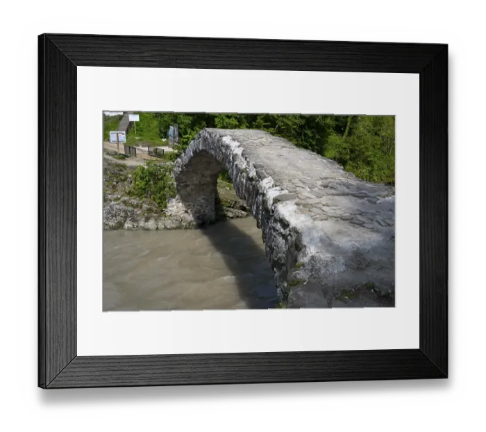 Framed Print : Old stone bridge spanning a river in green surroundings Framed Print : Old stone bridge spanning a river in green surroundings