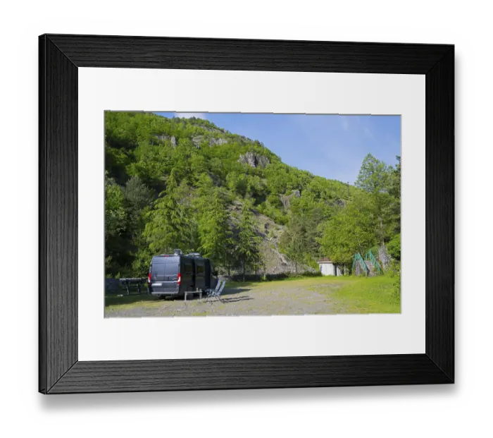 Framed Print : Motorhome is parked on an area in a mountainous and wooded area