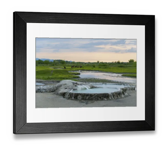 Framed Print : Hot spring pool in extensive nature with horses in the background under an evening sky
