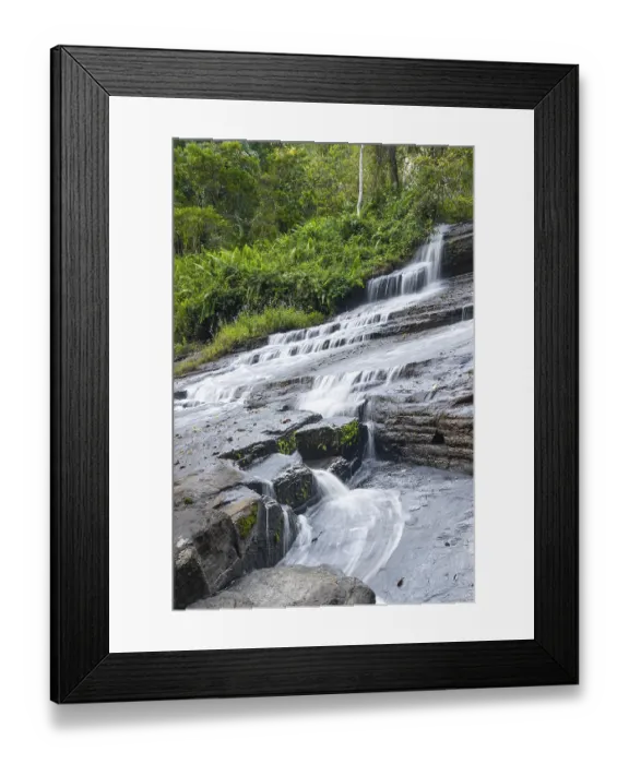 Framed Print : Derema Waterfall flows through thick vegetation