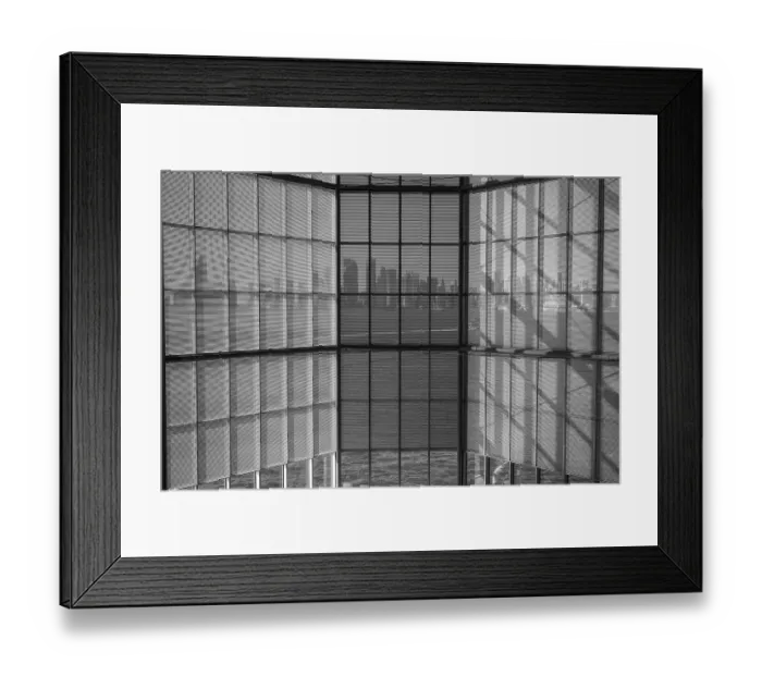 Framed Print : Black and white photo of glass windows reflecting a distant cityscape Framed Print : Black and white photo of glass windows reflecting a distant cityscape