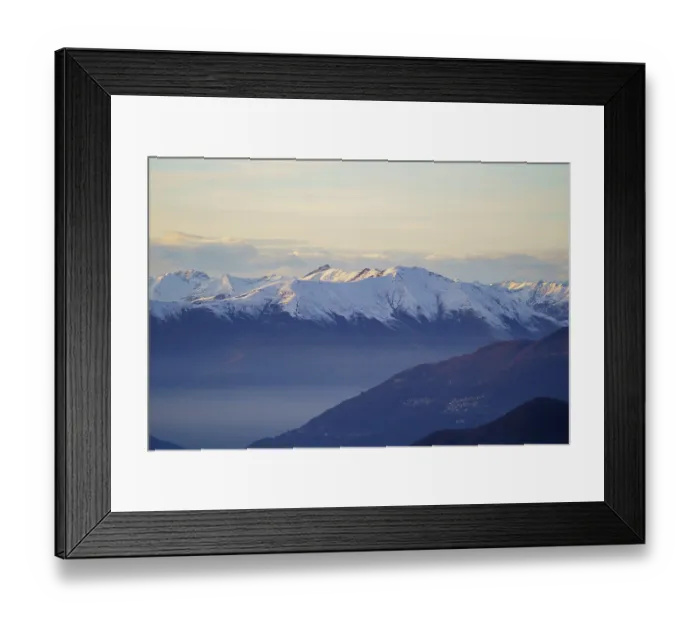 Framed Print : Misty valley lies beneath snow-capped mountain peaks at dusk near Piani di Bobbio in Italy Framed Print : Misty valley lies beneath snow-capped mountain peaks at dusk near Piani di Bobbio in Italy