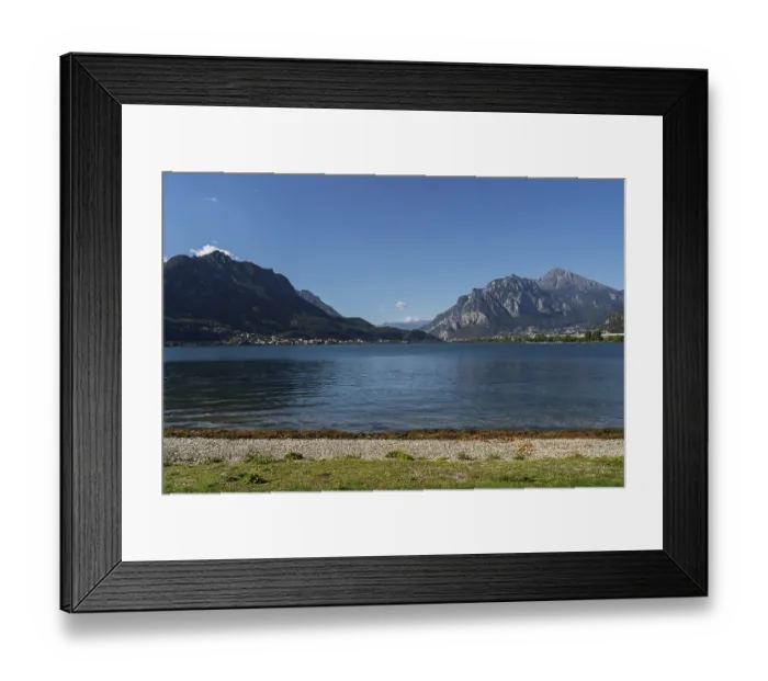 Framed Print : Peaceful lakeside beach with pebbles and grassy shoreline Framed Print : Peaceful lakeside beach with pebbles and grassy shoreline