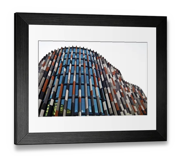 Framed Print : Modern skyscraper with a colorful facade of glass panels and abstract design