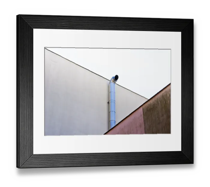 Framed Print : Industrial pipe extending along a minimalistic white wall with geometric shapes Framed Print : Industrial pipe extending along a minimalistic white wall with geometric shapes