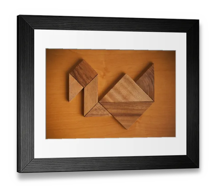 Framed Print : A wooden tangram puzzle arranged to resemble a bird