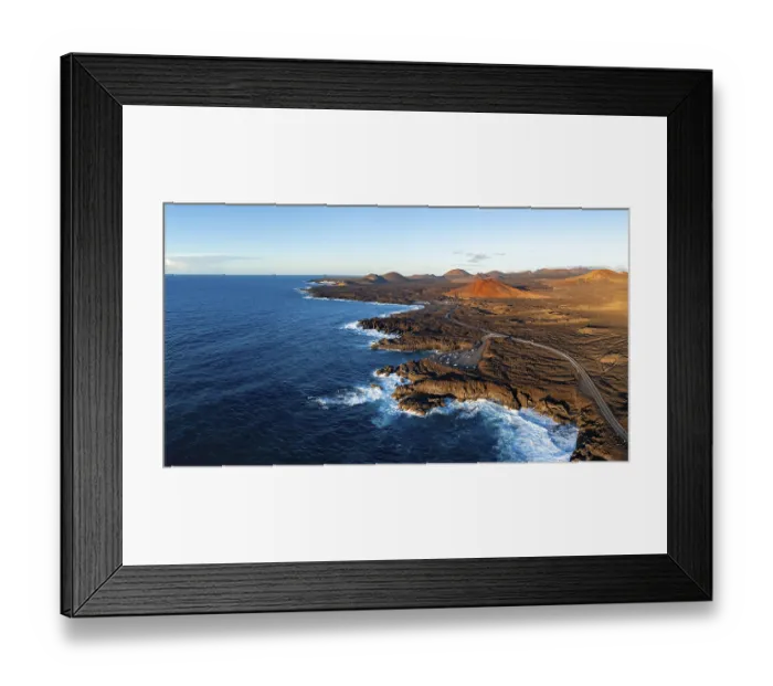 Framed Print : Coast with lava fields, volcanic landscape near Los Hervideros with red volcano Montana Bermeja