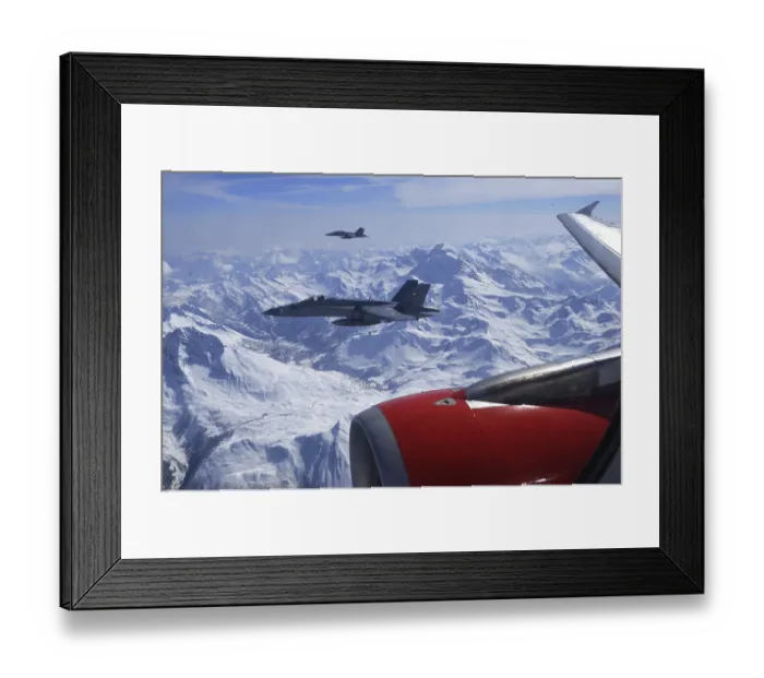 Framed Print : Two FA-18 Fighters Accompaning a Civil Airplaine over the Swiss Alps