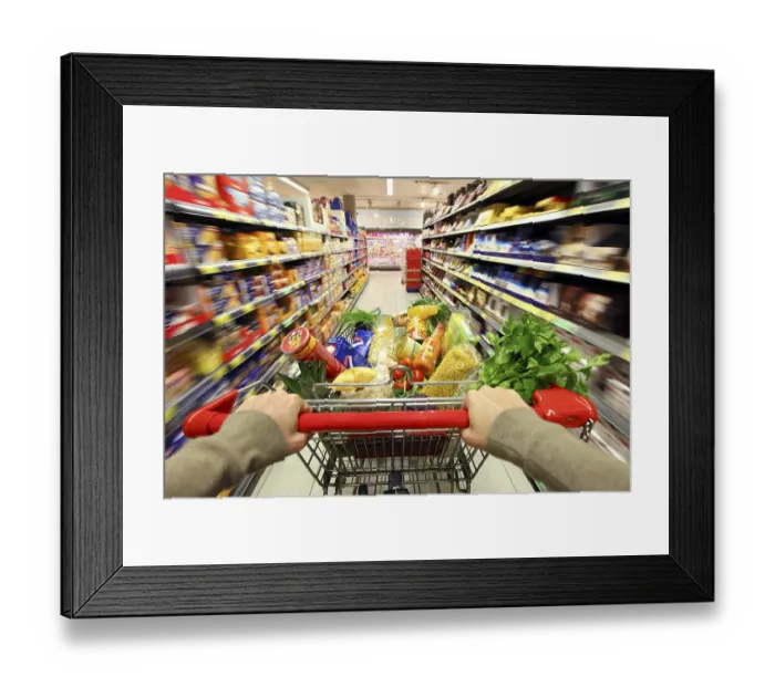 Framed Print : Full shopping trolley being pushed down the aisle
