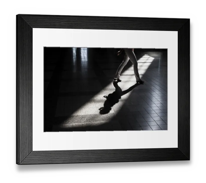 Framed Print : Woman casting a shadow on the floor of a building