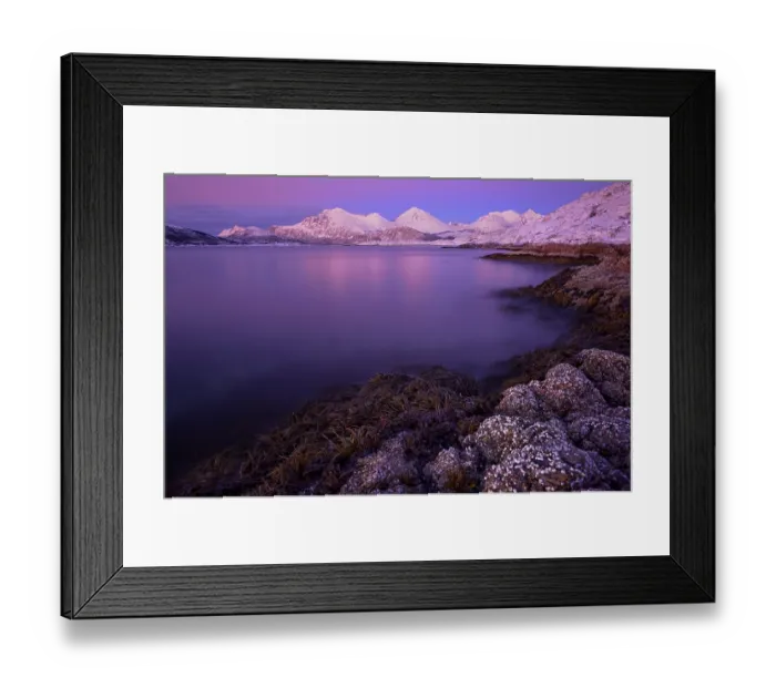 Framed Print : Fjord with stones in front of a mountain range in the evening light Framed Print : Fjord with stones in front of a mountain range in the evening light