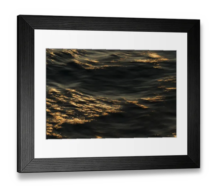 Framed Print : Reflections of the setting sun on the water surface