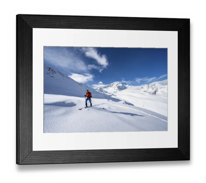 Framed Print : Ski tourers in a snow-covered mountain landscape Framed Print : Ski tourers in a snow-covered mountain landscape