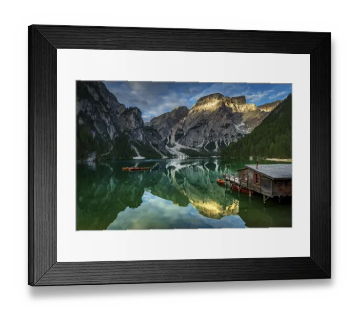Framed Print : Green mountain lake with boats and boathouse
