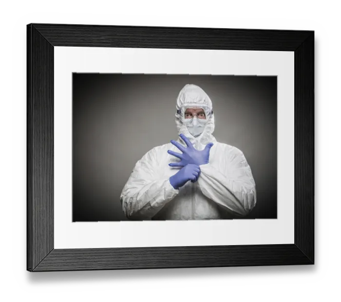 Framed Print : Man with intense expression wearing HAZMAT protective clothing against A gray background