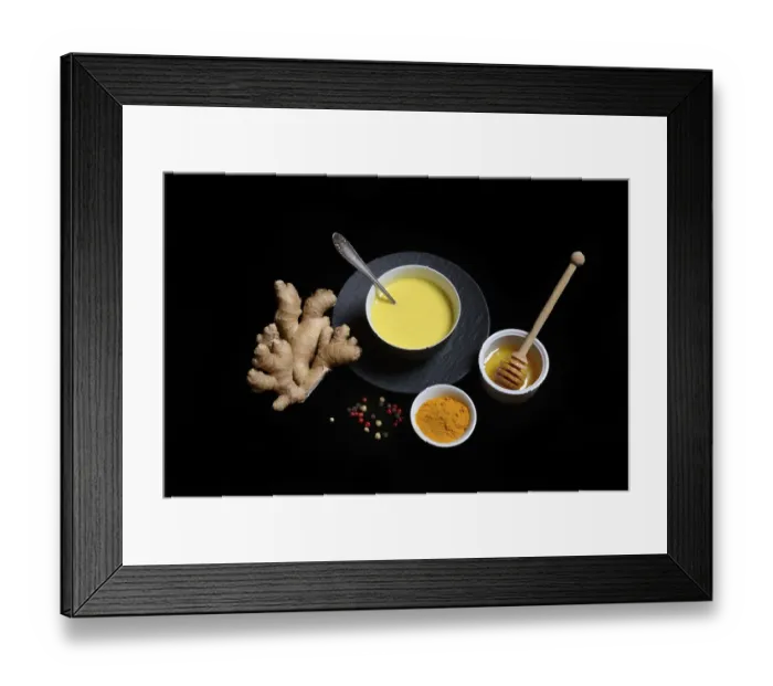 Framed Print : Turmeric milk in bowl, turmeric powder and ginger bulb