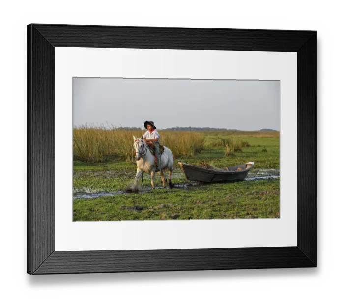 Framed Print : Young gaucho pulling a boat with reeds Framed Print : Young gaucho pulling a boat with reeds