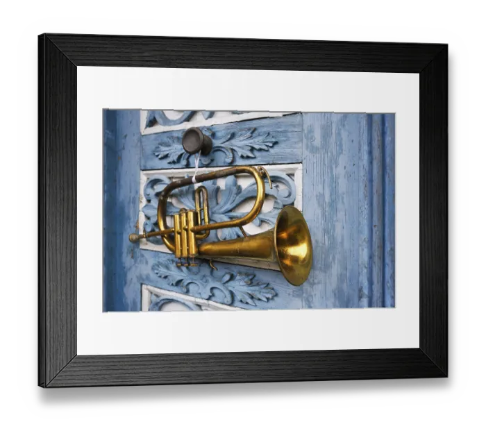 Framed Print : Trumpet hanging on an old ornate wooden door