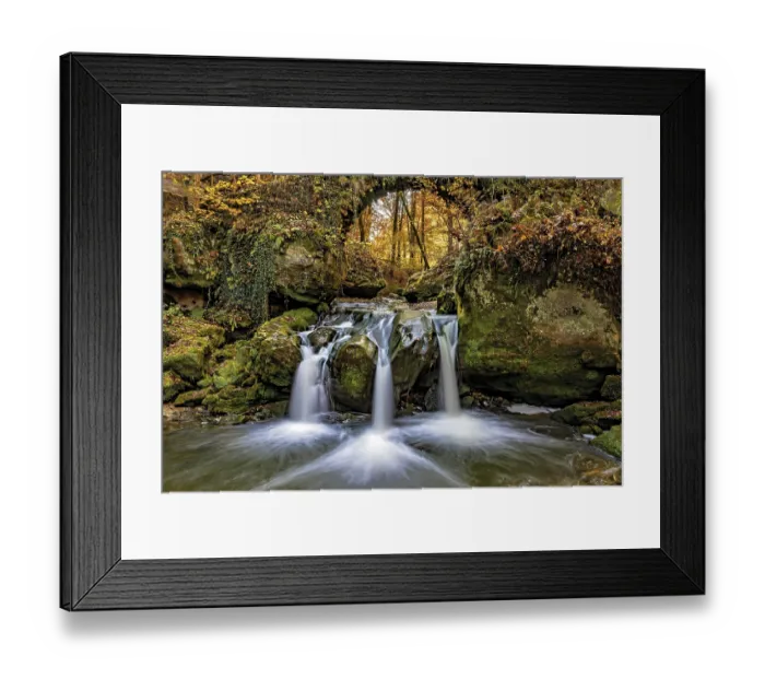 Framed Print : The three-armed Schiessentumpel waterfall in the Mullerthal in Luxembourg in sunny autumn weather as a long