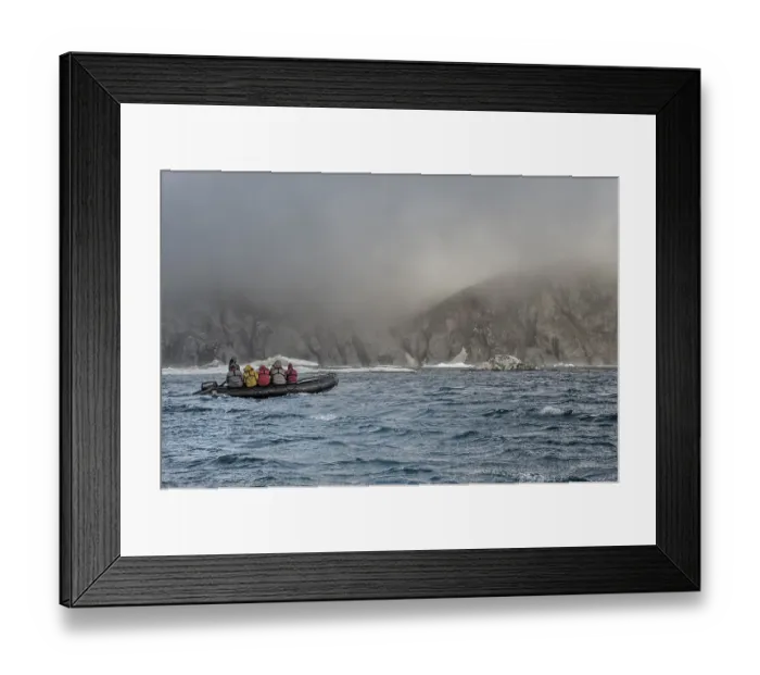 Framed Print : Tourists in an inflatable boat approaching Herald Island