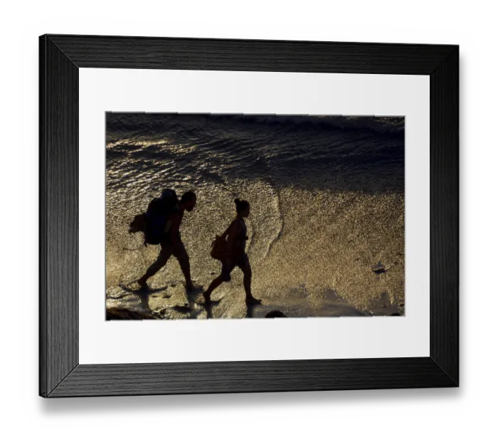 Framed Print : Two backpackers walking along the beach Framed Print : Two backpackers walking along the beach