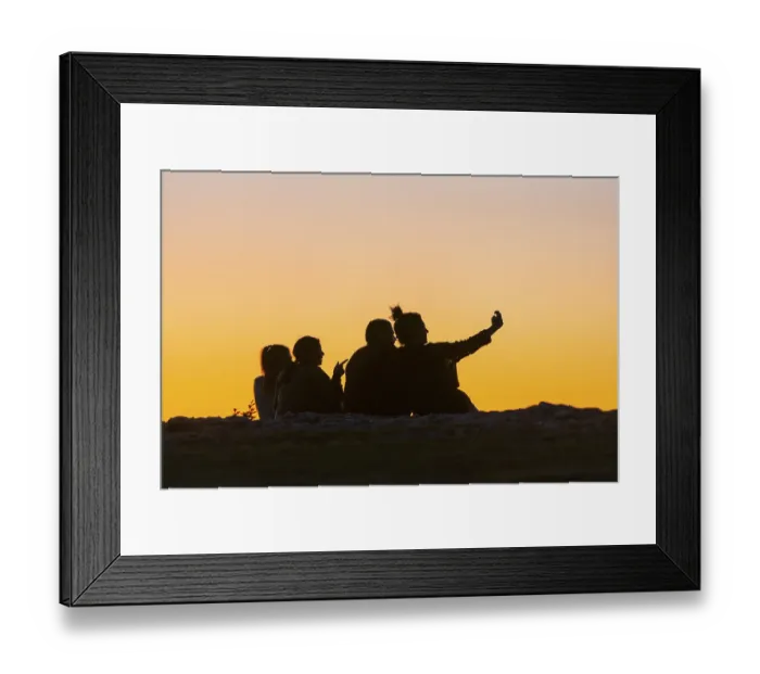 Framed Print : Young woman and men, twilight, talking