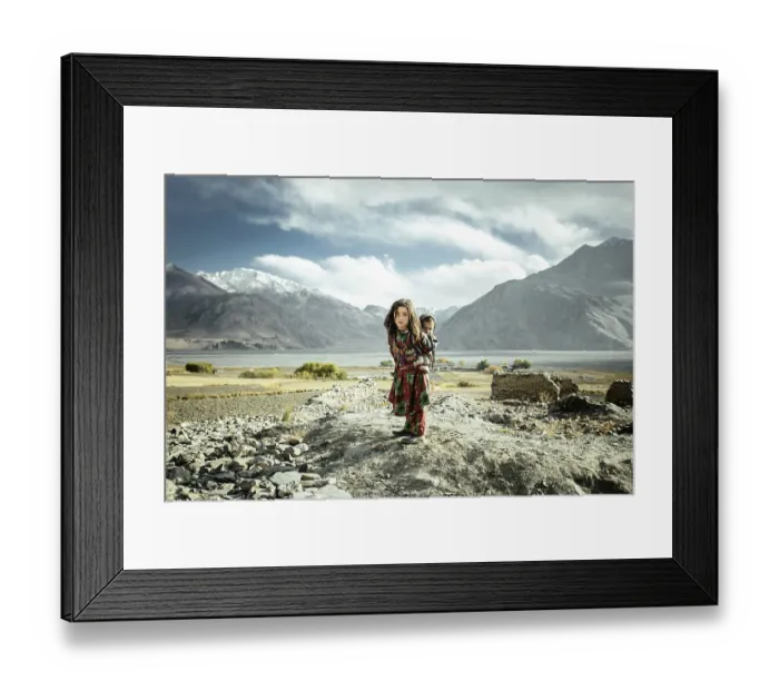 Framed Print : Girl carrying her little brother on her back