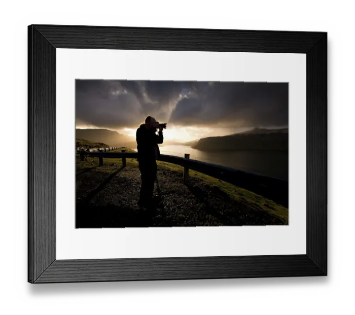 Framed Print : Silhouette of a photographer standing in front of dramatic