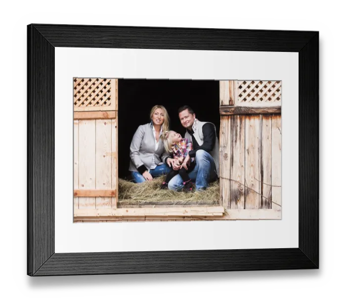 Framed Print : Young family sitting in the hay barn