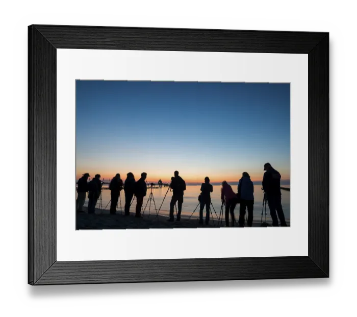 Framed Print : People photographing on the beach near the pier
