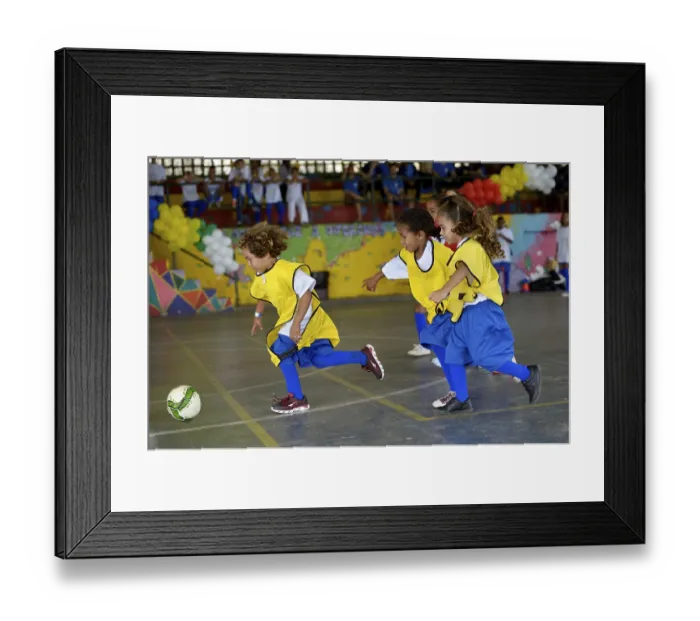 Framed Print : Soccer tournament with children on the sports ground of a slum Framed Print : Soccer tournament with children on the sports ground of a slum