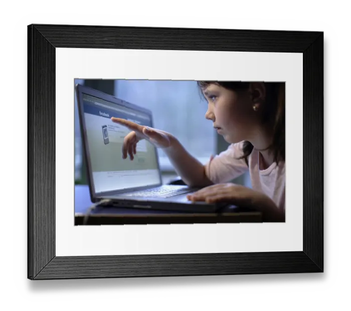 Framed Print : Girl, 10 years, with laptop, on Facebook web page Framed Print : Girl, 10 years, with laptop, on Facebook web page