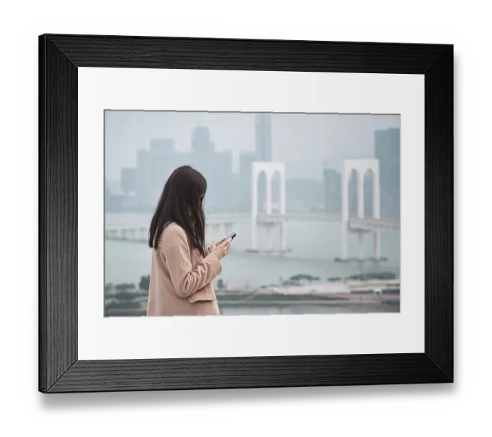 Framed Print : Woman, using phone with Sai Van Bridge in the background