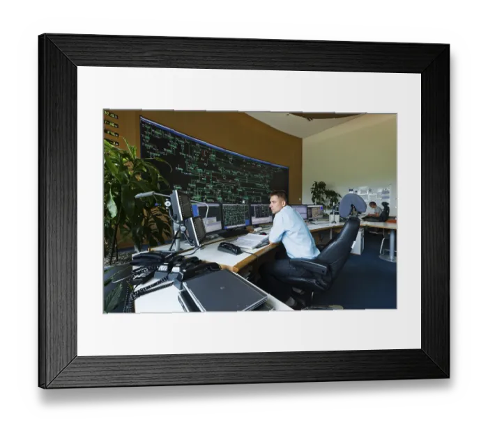 Framed Print : Engineer sitting at his work station in the Transmission Control Center