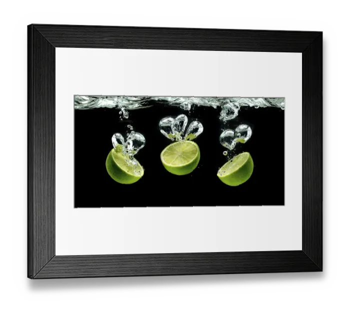 Framed Print : Three lime halves, splashing into water against black Framed Print : Three lime halves, splashing into water against black