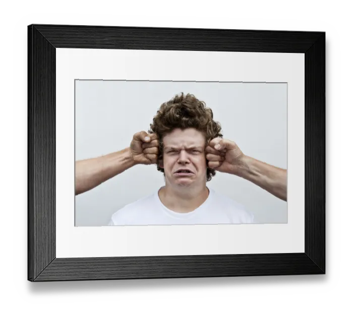 Framed Print : Two fists attacking the head of a young man Framed Print : Two fists attacking the head of a young man