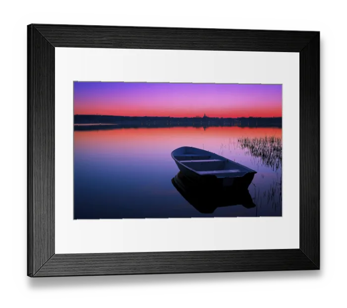 Framed Print : Boat in the background of the lake at a beautiful sunset